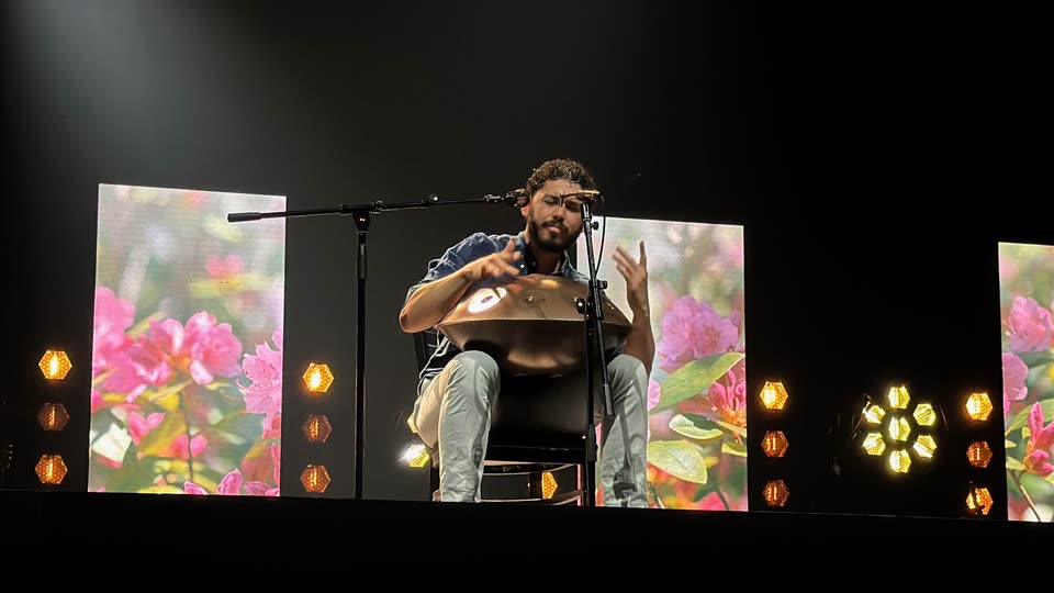 Andrew performing with a handpan during an LCU talent show